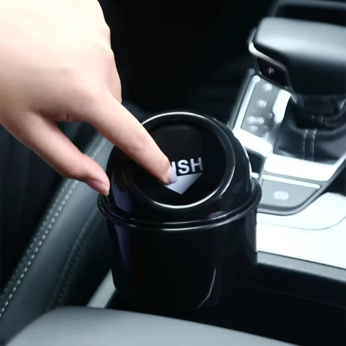Pressing the lid on the trash can